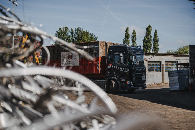 Anlieferung eines Metallschrott-Containers – individueller Containerservice für Baugewerbe, Schifffahrt und Abbruchunternehmen
